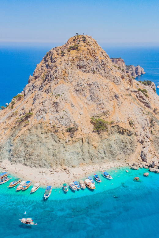 From Antalya: Suluada Island Boat Trip with Lunch - Stop 1 on Suluada: clear water, pebbly beach, and the crowd factor